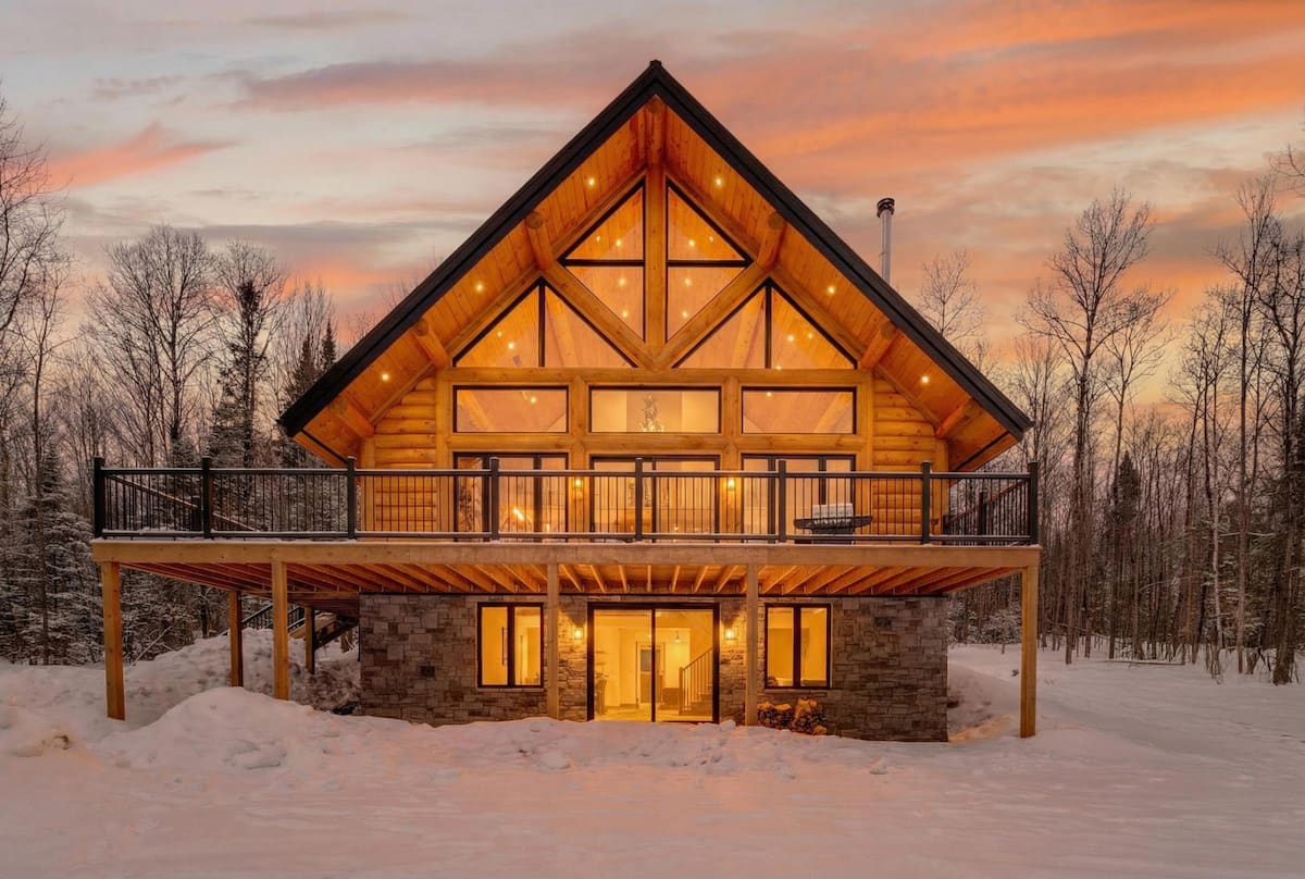 Front exterior of Kanata Tremblant glowing at sunset in winter