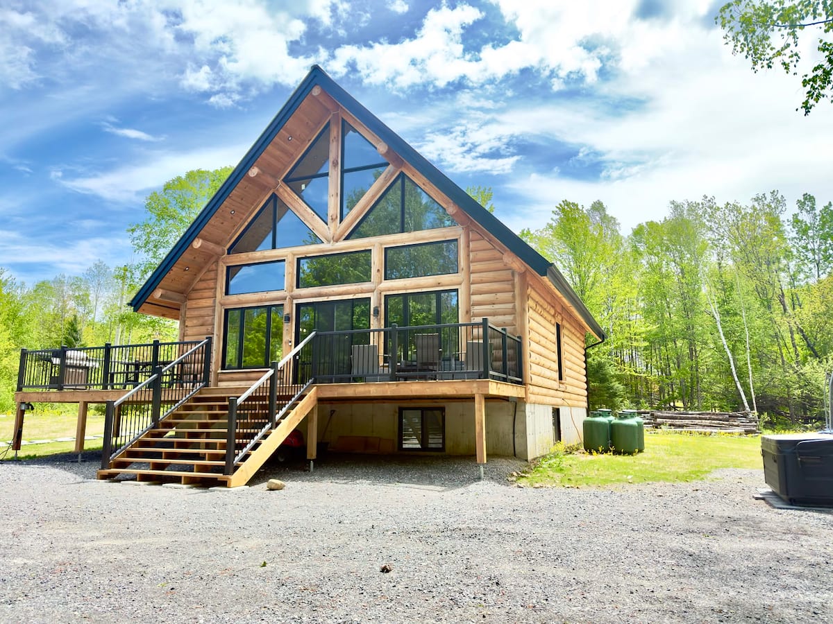 Front exterior of Envision Tremblant beneath a bright blue sky